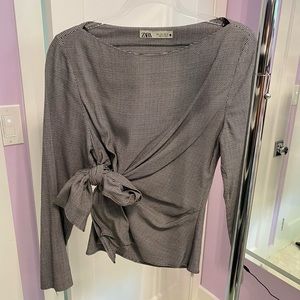 Black and white (comes across grey) wide neck side tie blouse